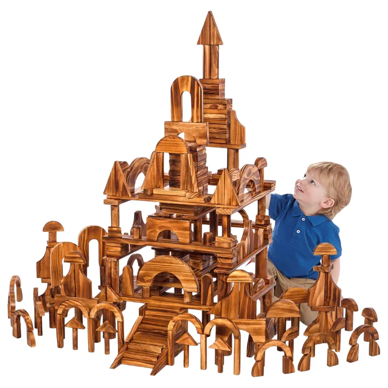Preschool child building large structure with outdoor nature-inspired wooden blocks in a creative STEM play setting