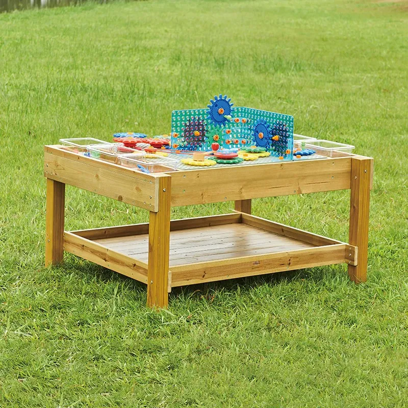 Outdoor STEM exploration table with integrated measurement tools and sensory bins for preschool science play