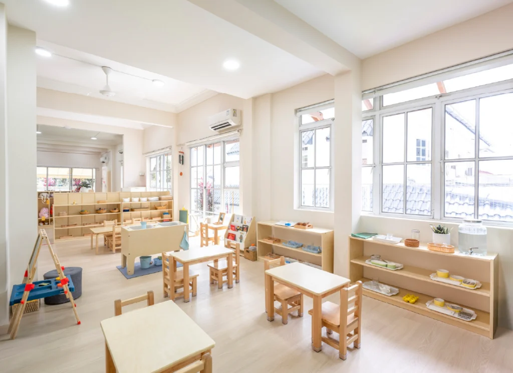 Modern Montessori preschool classroom with natural wood furniture and learning materials in Singapore
