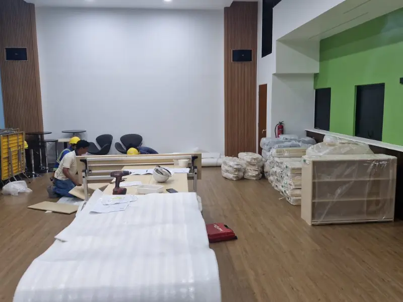 Professional installation team assembling kindergarten furniture and equipment in Singapore classroom