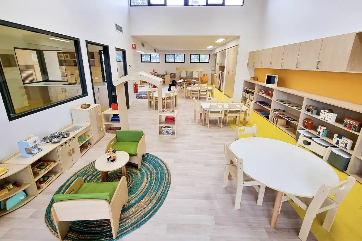 Bright Steps Academy modern childcare classroom with natural wood furniture