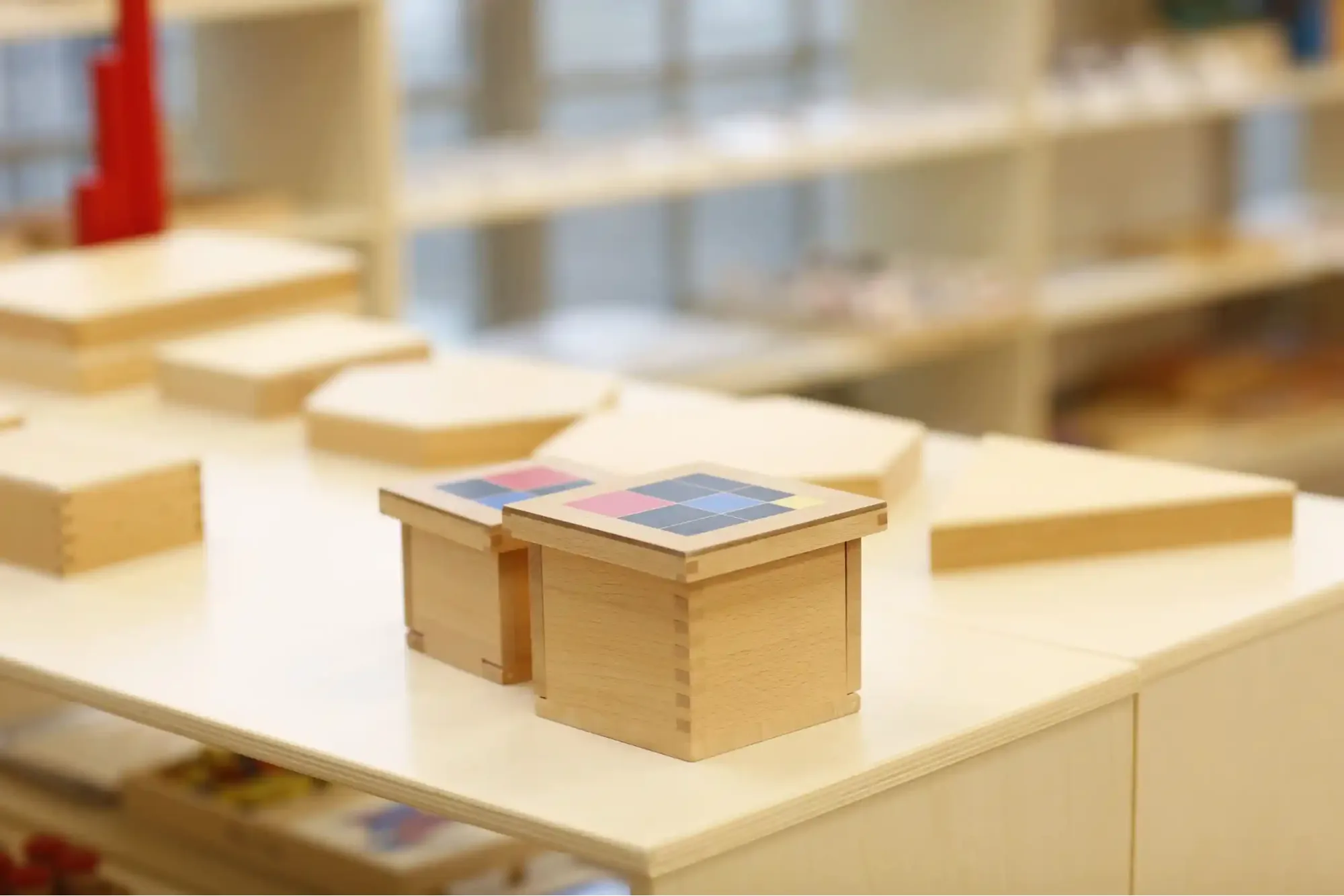 Bright early years classroom with child-sized tables and open shelving
