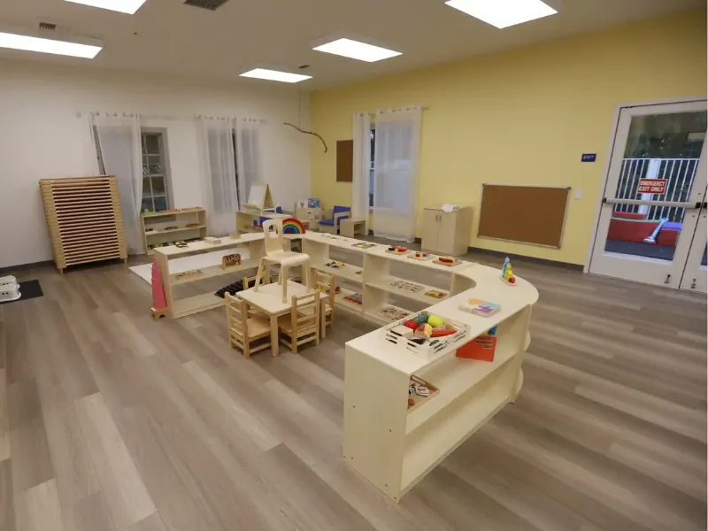 Montessori sensorial materials on low wooden shelf in Irish preschool