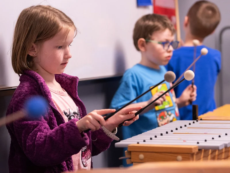 Preschool children playing music toys