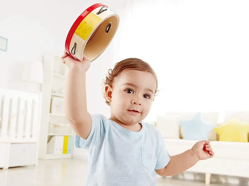Toddler playing tambourine music toy