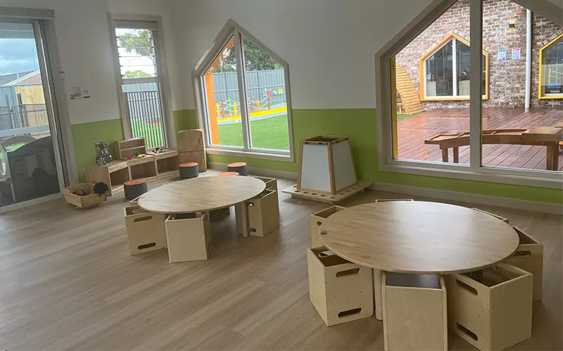 Round preschool tables and cube chairs in a client classroom