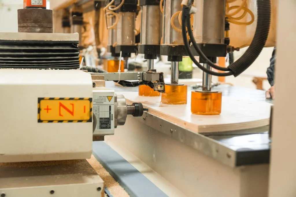 CNC machine hold-down cups on a plywood panel in the West Shore Dalian factory