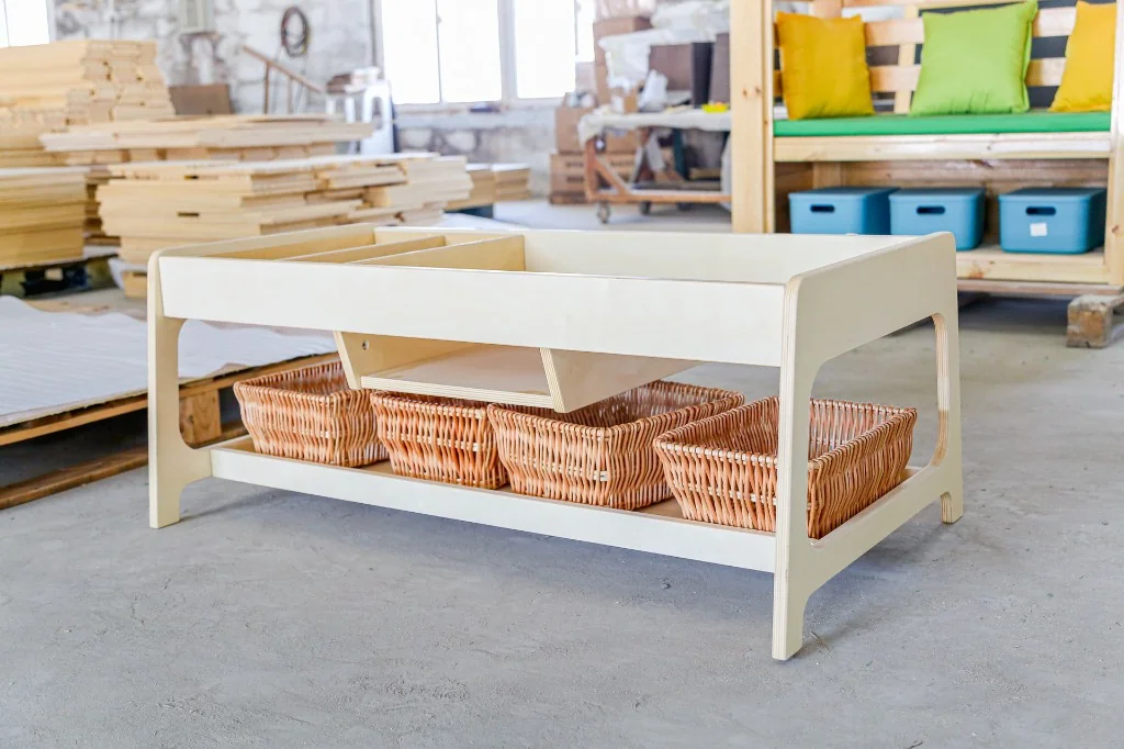 Birch preschool activity table with a divided tray top and four wicker baskets underneath