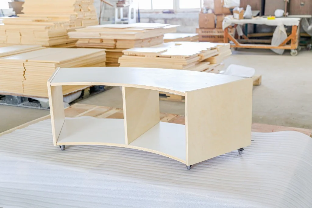 Low curved birch preschool shelf with two open compartments on casters