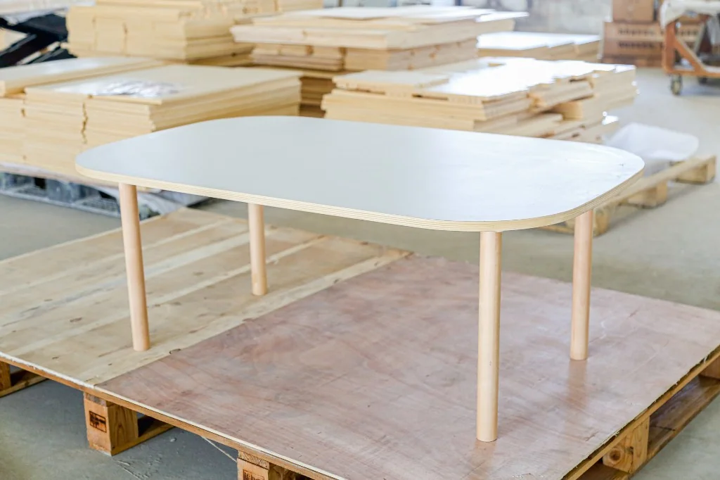 Rounded-rectangle white laminate preschool classroom table with four birch legs