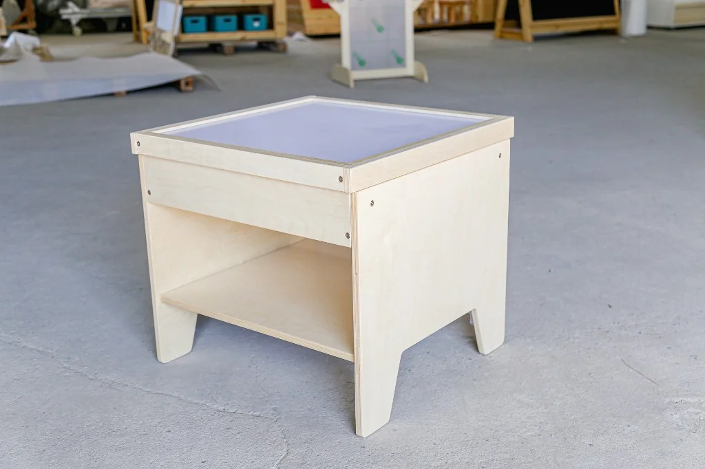 Small square birch preschool light table with a frosted top and open shelf