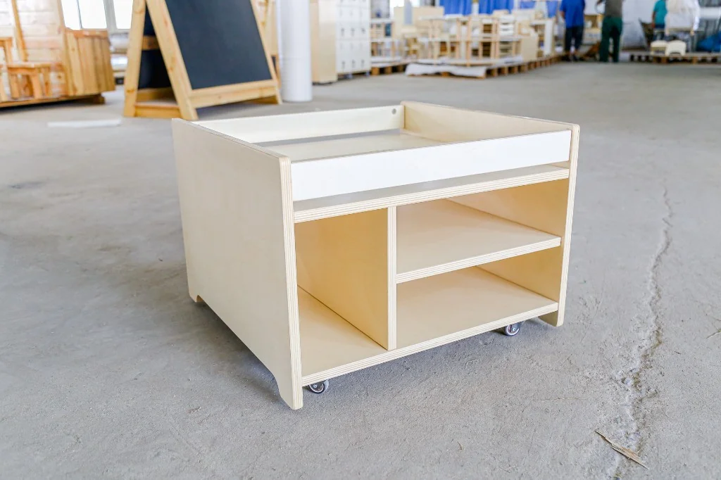 Square mobile preschool sensory table with a raised tray top and open cubbies underneath