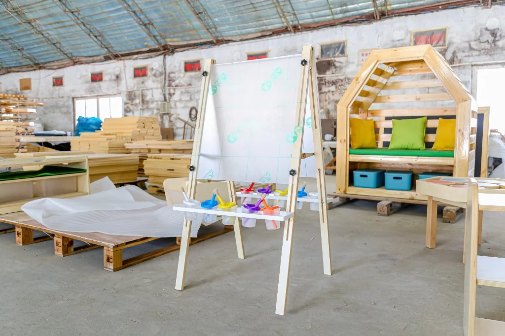Wooden preschool A-frame paint easel with six colour cups in the factory