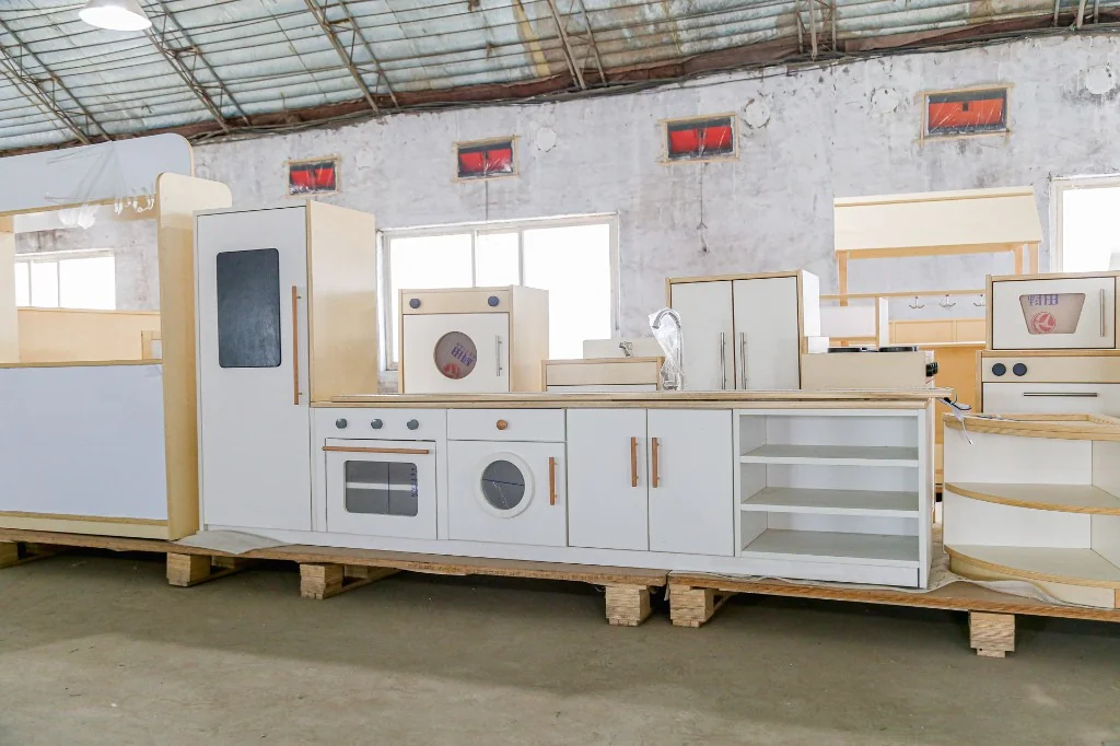 Full modular preschool play kitchen lineup with fridge, washer, sink and cabinets