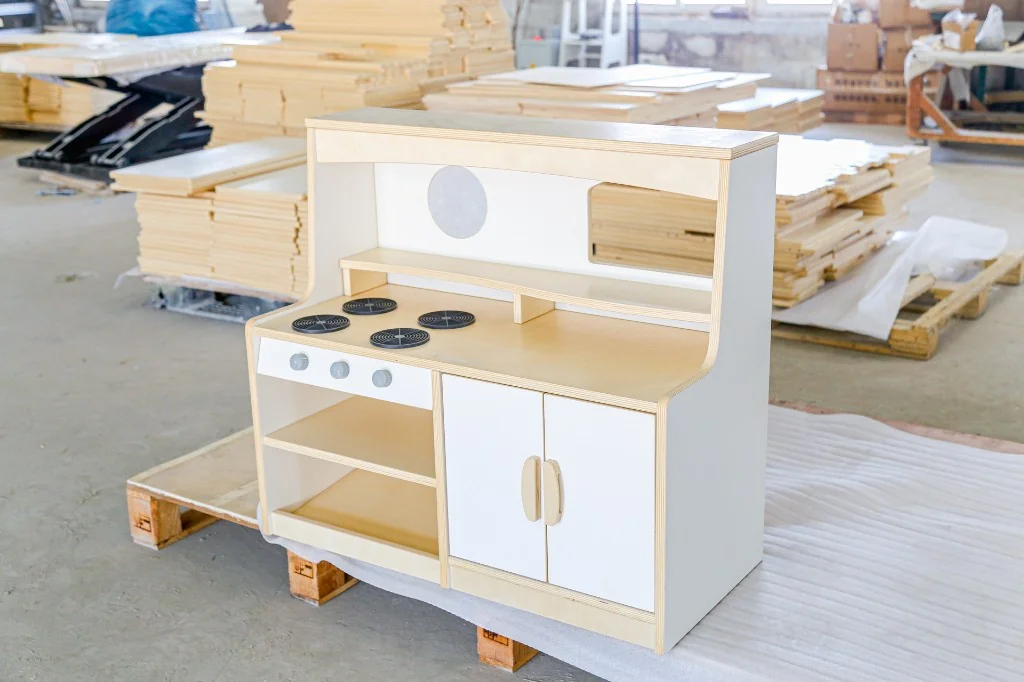 White preschool play stove with a hutch shelf, burners and cupboard doors