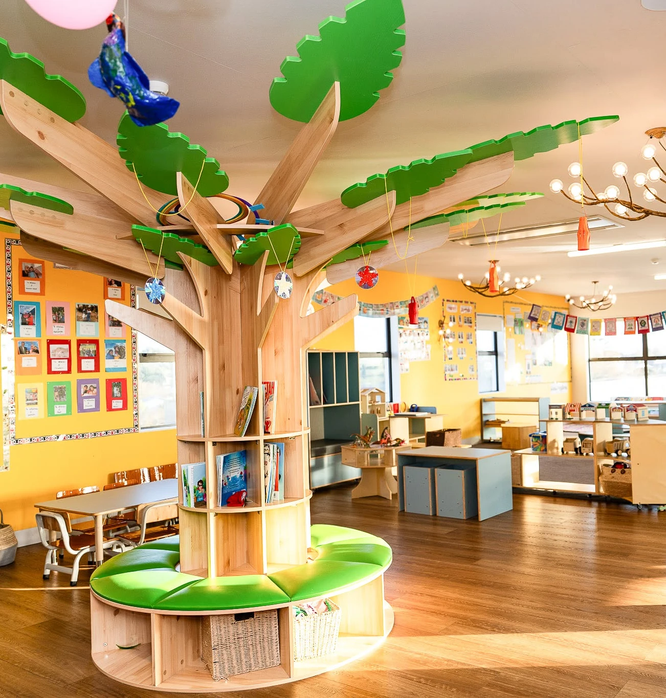 Full classroom reading tree bookshelf with green bench and canopy